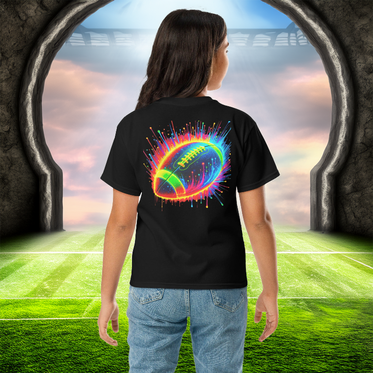 A young girl wears the Neon Gridiron Youth Tee in black, showcasing a dynamic neon football explosion on the back. She stands at the gateway to a futuristic football field, symbolizing energy, speed, and passion for the game. A perfect tee for young athletes and football fans who love bold, high-impact designs.