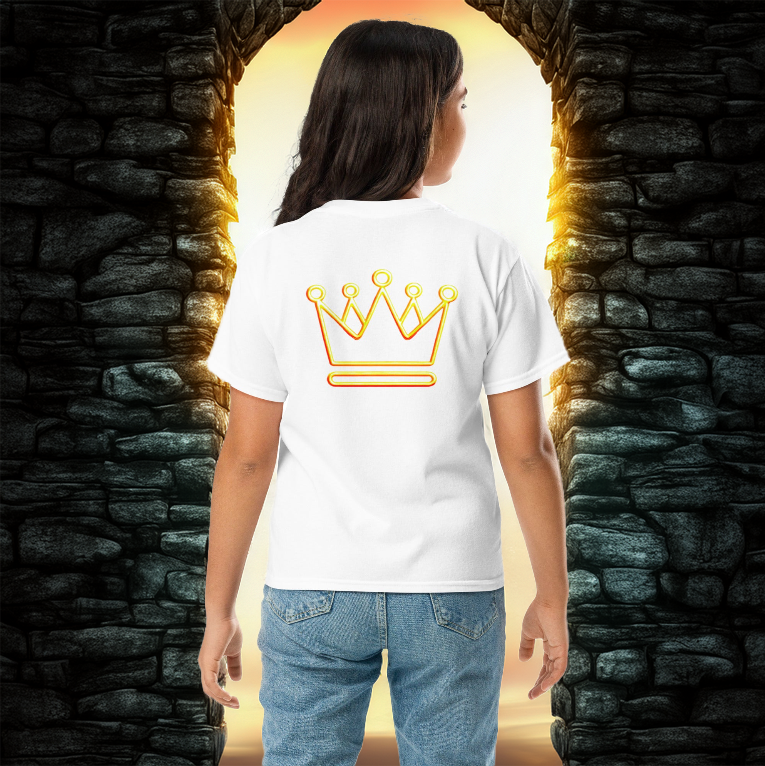 A young girl wearing a white t-shirt with a neon gold crown design on the back, standing between two ancient stone pillars with golden sunlight streaming through.