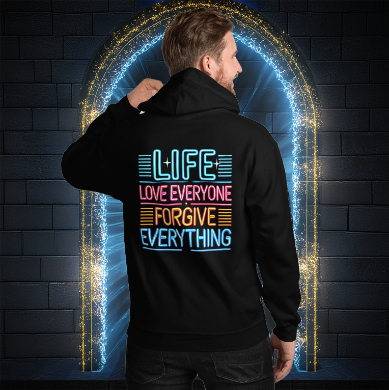 A man wearing a black hoodie with a bold neon-style message on the back that reads "LIFE - LOVE EVERYONE - FORGIVE EVERYTHING," standing in front of a glowing portal.