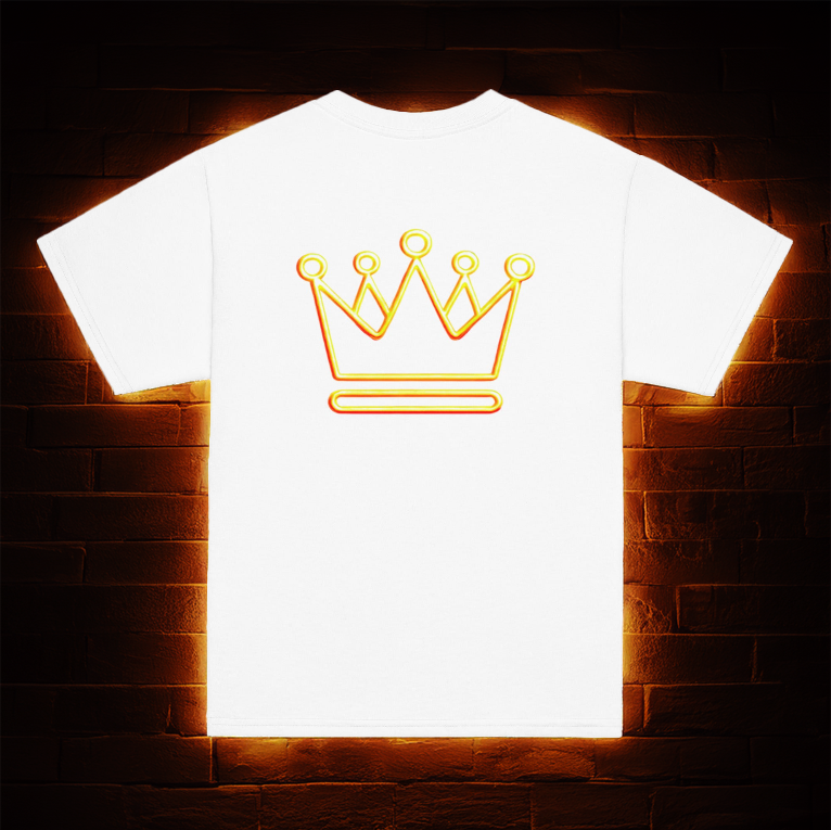 White t-shirt featuring a neon gold crown design on the back, displayed against a dark brick wall with a warm golden glow illuminating the background.