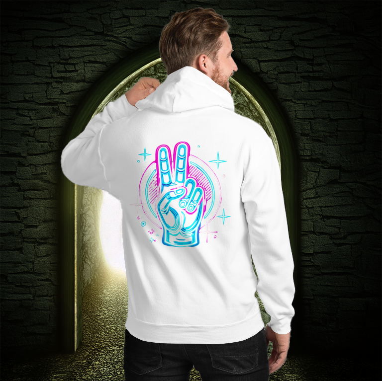 Man wearing a white hoodie with a neon peace hand sign design on the back, standing in front of a glowing arched doorway with a dark stone background.